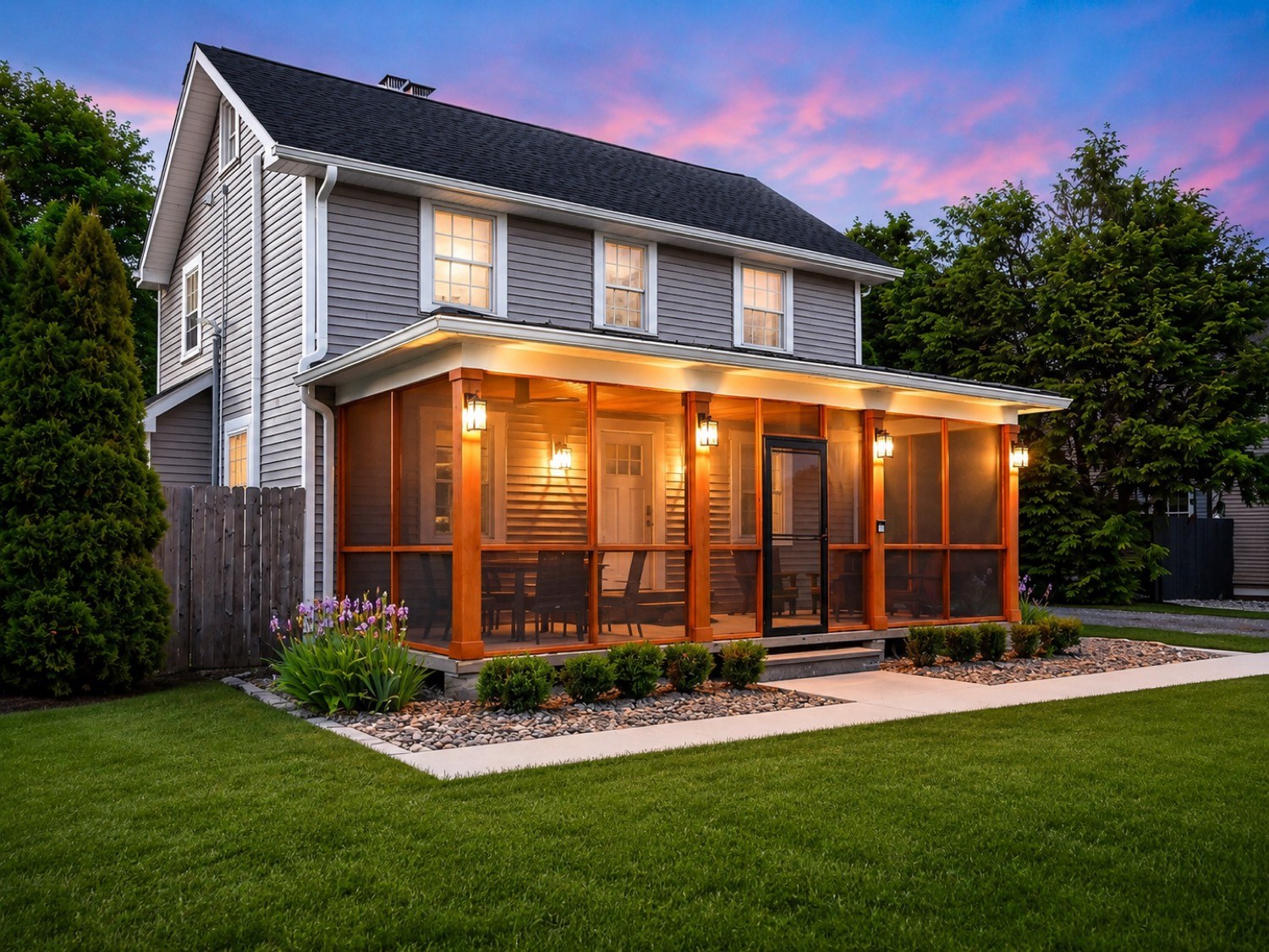 Screened porch glowing at dusk